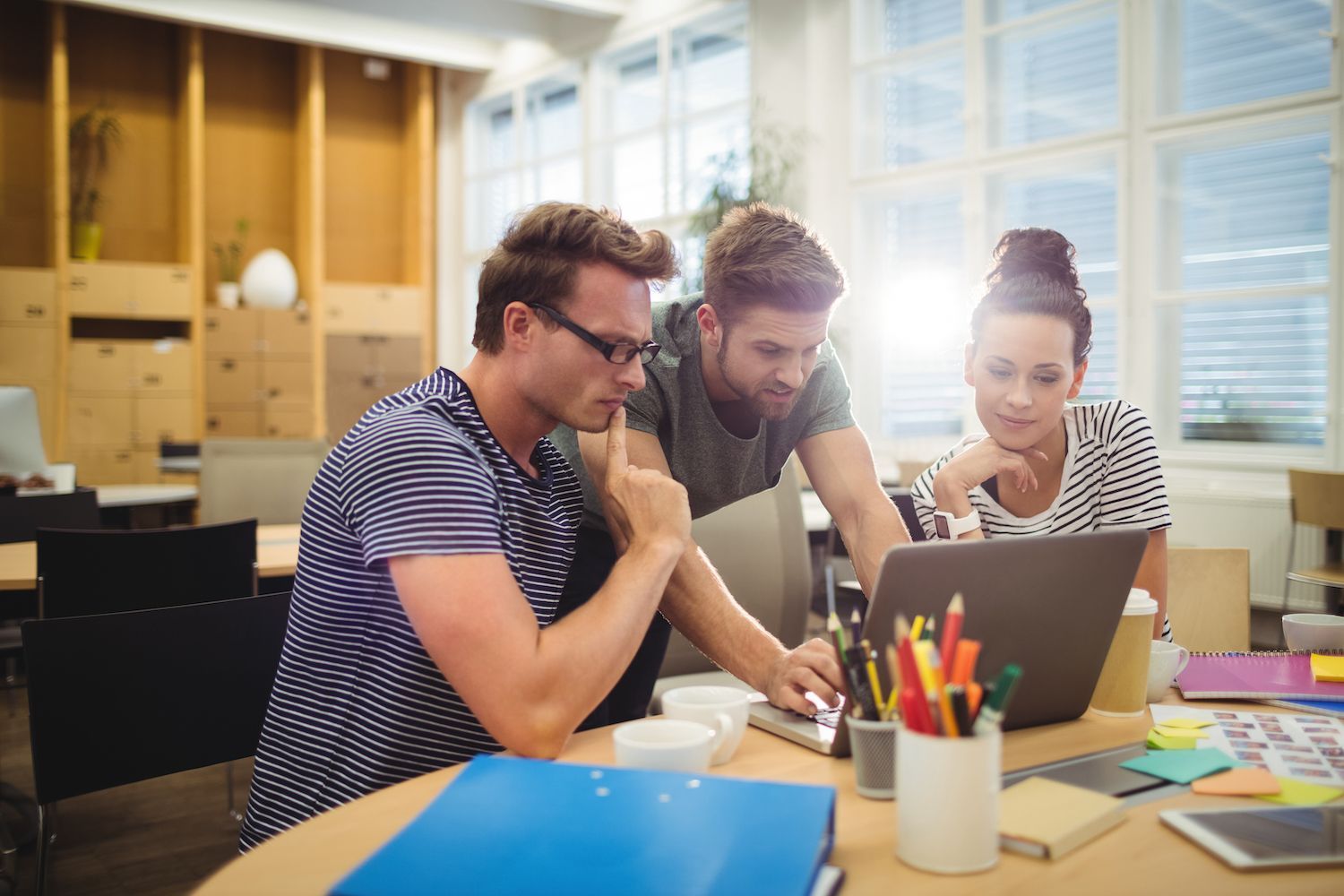 A set of developers who are looking at their screens while working. 